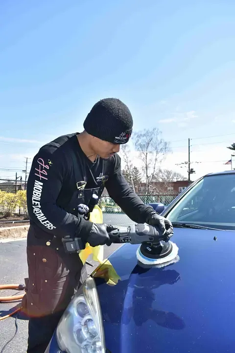 Machine polishing a blue hood